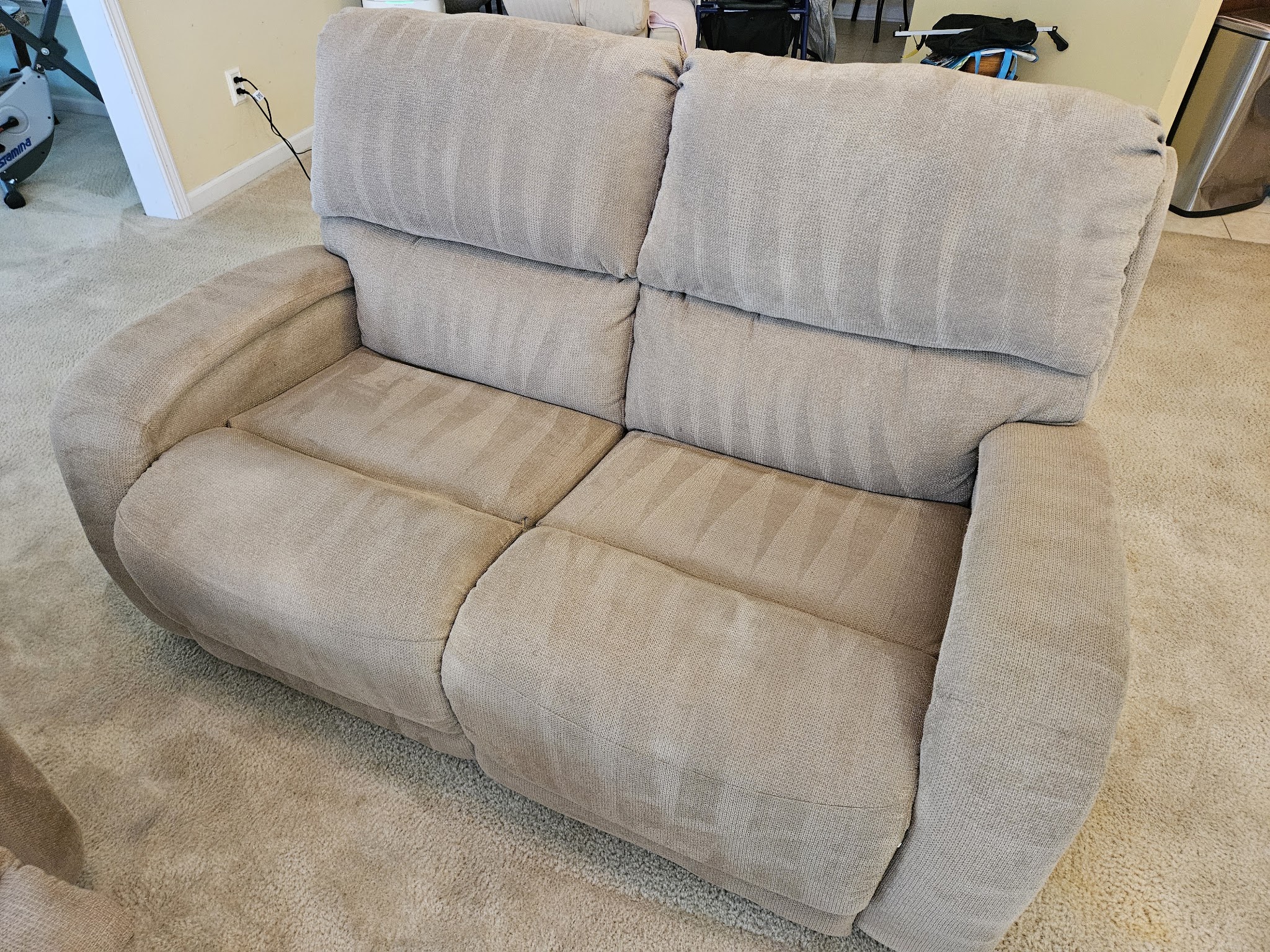 A cleaned fabric loveseat on freshly cleaned carpet